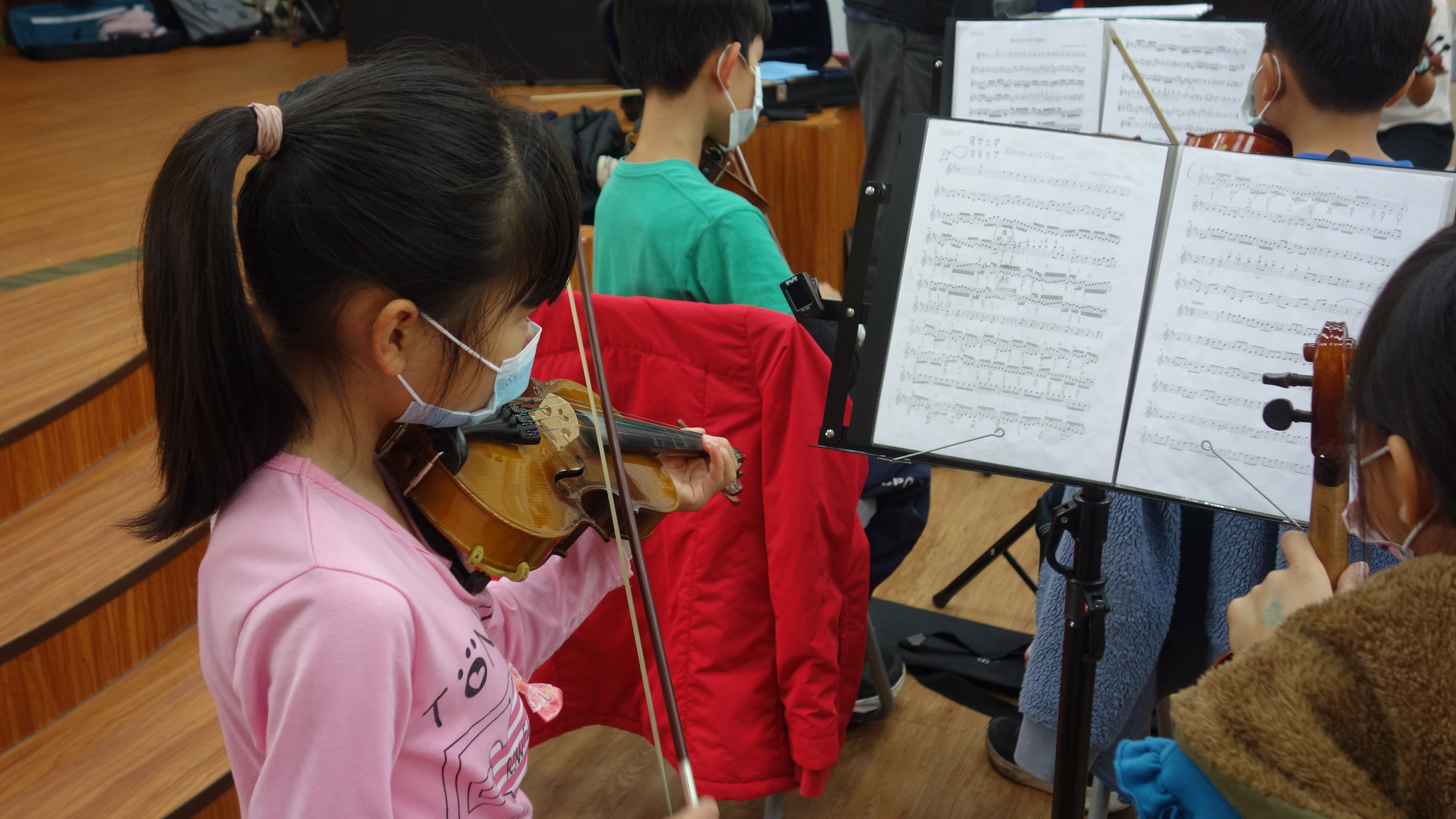 吳厝國小的學生專注地盯著樂譜及指揮老師演奏