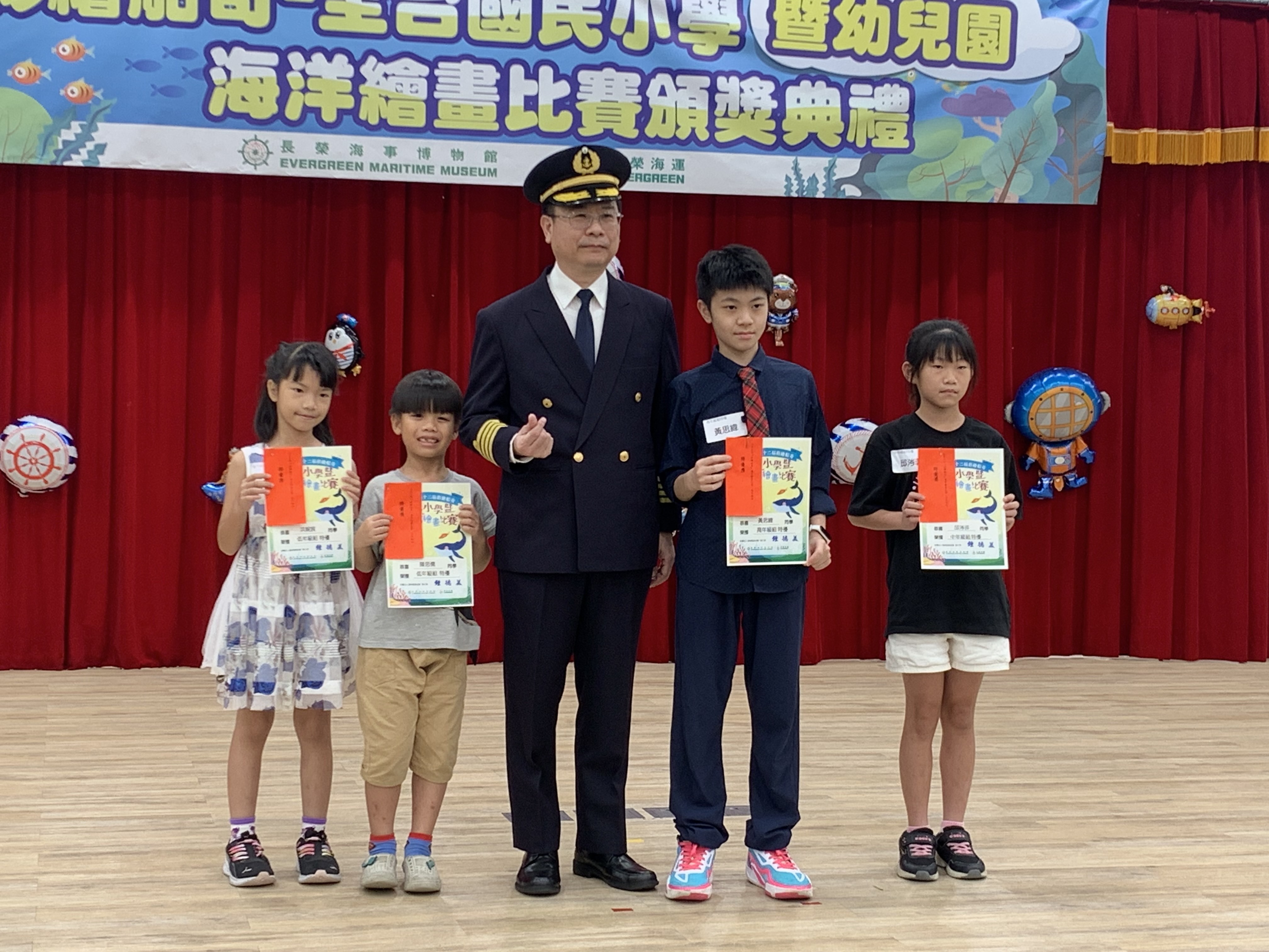 長榮海運黃義恩船長(中)頒發特優獎項給獲獎小朋友