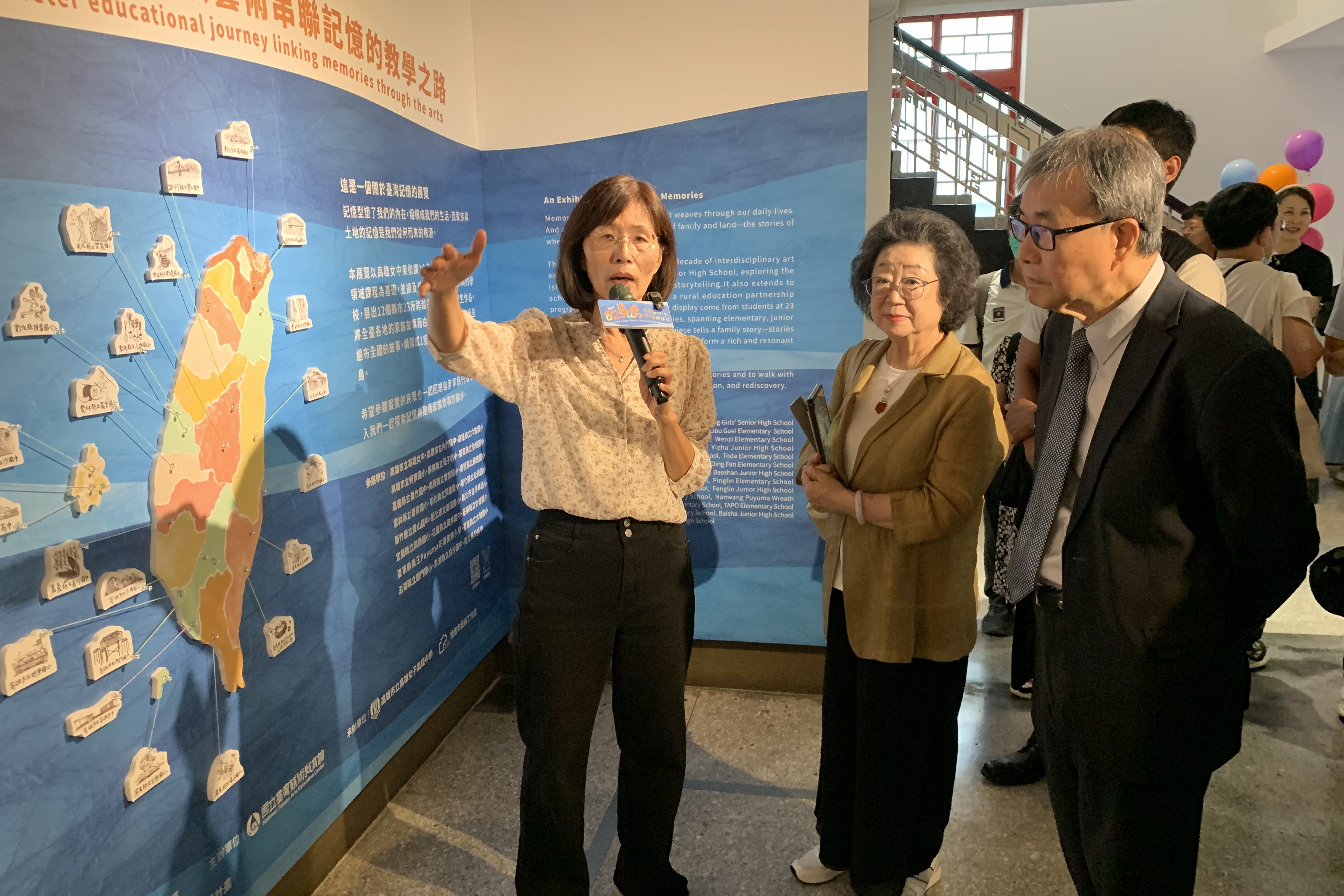 教育部長鄭英耀、監察委員范巽綠聆聽策展人劉癸容老師進行導覽 (記者攝)