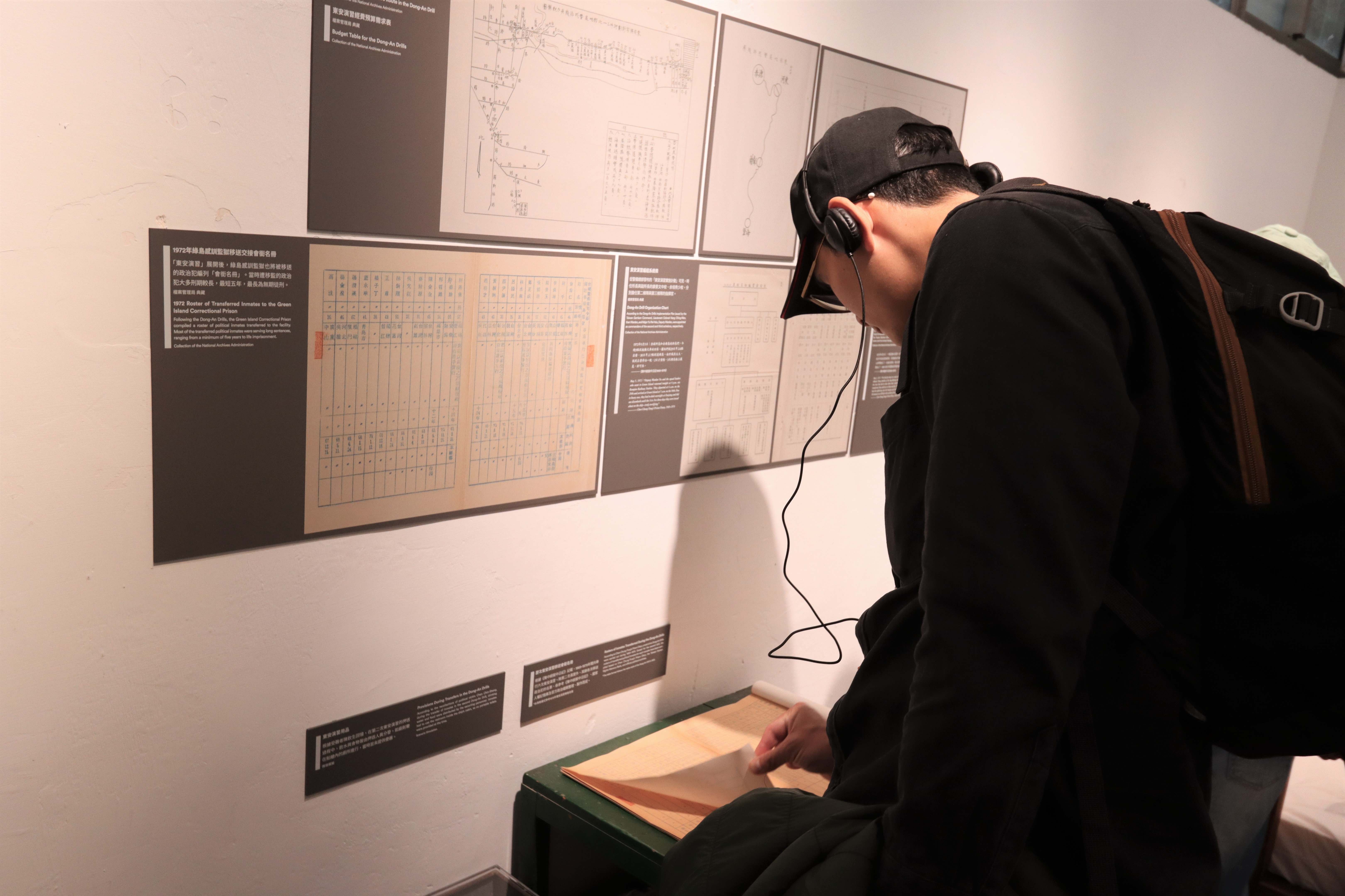參觀民眾仔細翻閱東安演習歷年來政治受難者的移送名單 (人權館提供)
